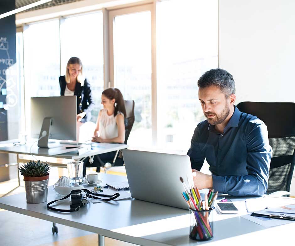 two people sitting at desk in an office enviroment