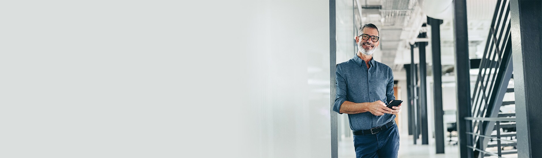 person leaning on wall and smiling