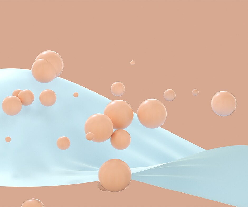 Pfirsichfarbene Kugeln fallen auf weißes, bandähnliches Objekt