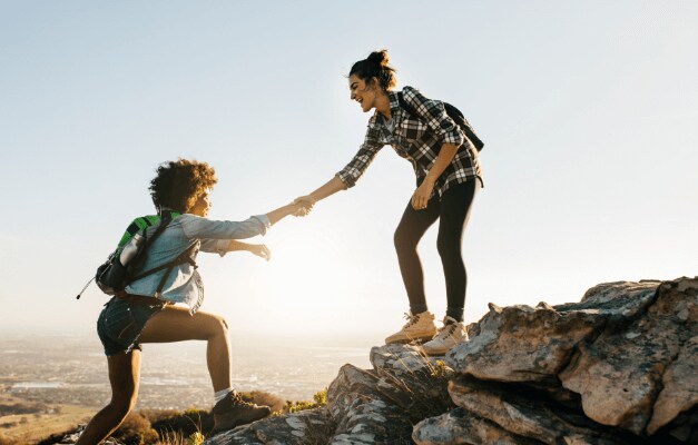 A hiker giving a helping hand to another hiker