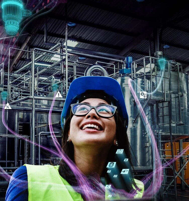 Operaio con dispositivi di protezione individuale all'interno di un impianto industriale con grafica digitale e icone che rappresentano la tecnologia intelligente