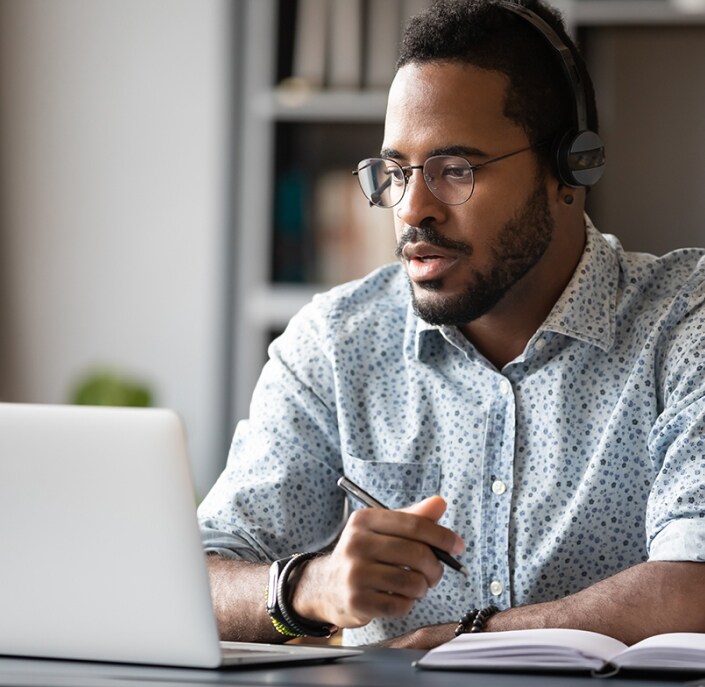 uomini che guardano un portatile e scrivono