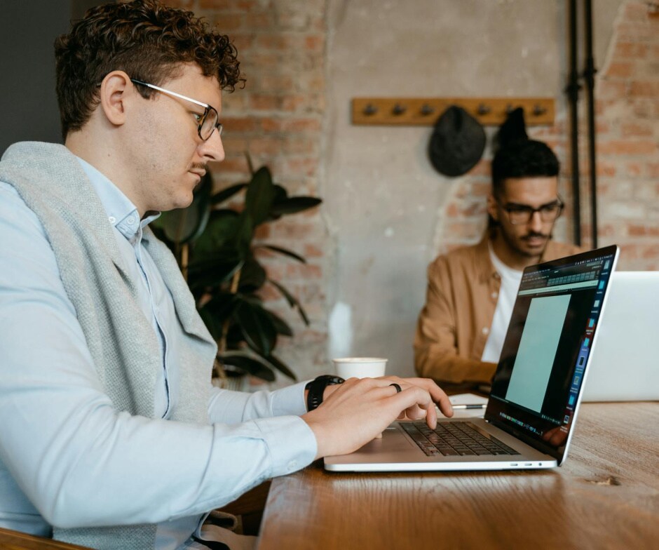 Two persons working on their laptops