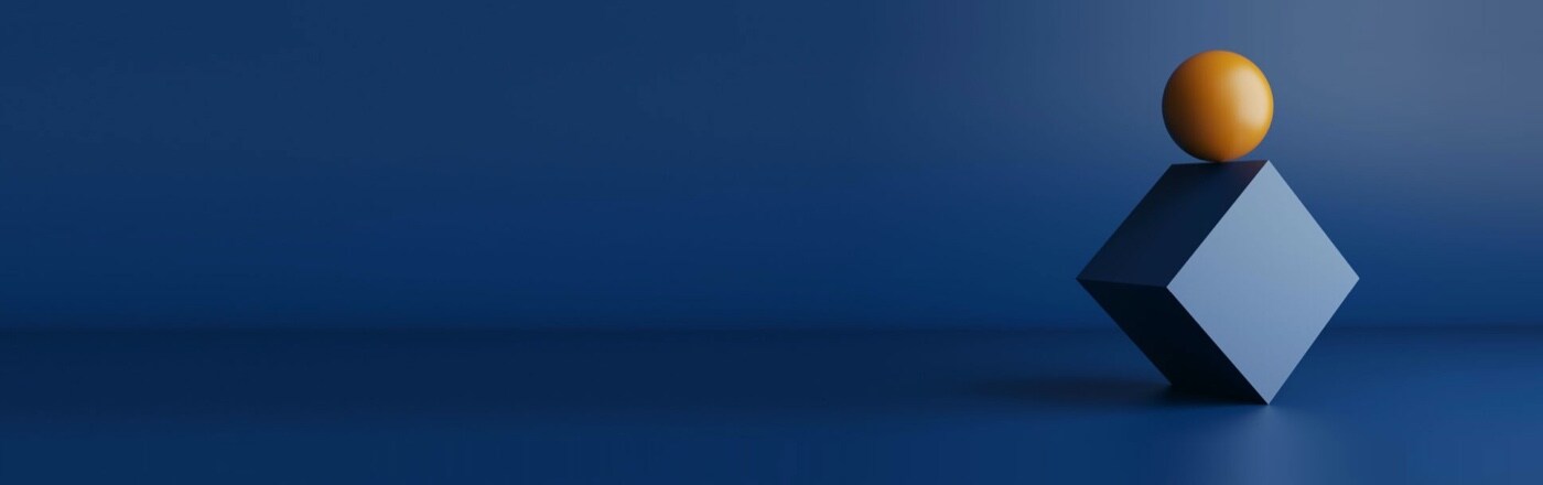 Orange sphere on top of blue cube