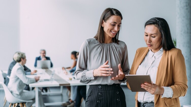 Two persons discussing by seeing the ipad