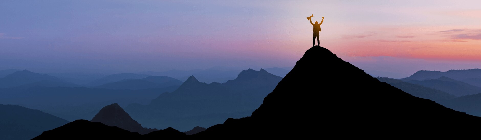person standing on a mountain summit