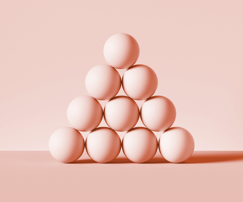 10 pink spheres stacked in pyramid on pink background