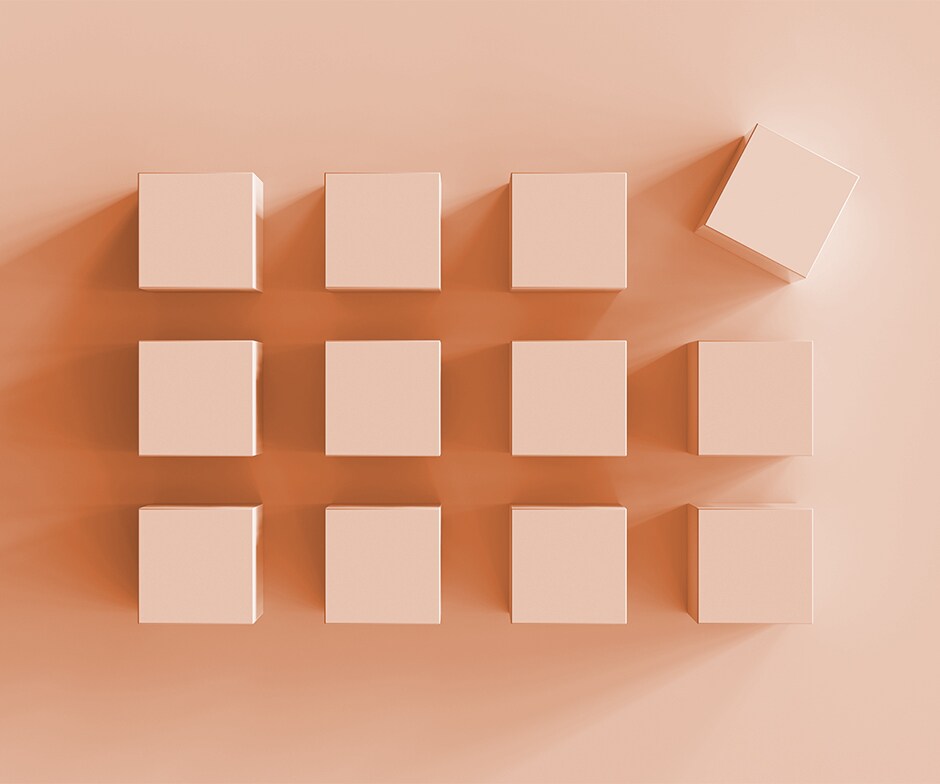 twelve pink cubes with one askew