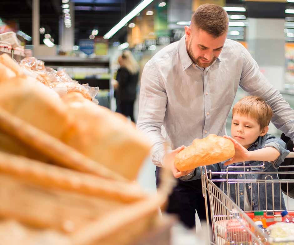 man grocery shopping with child