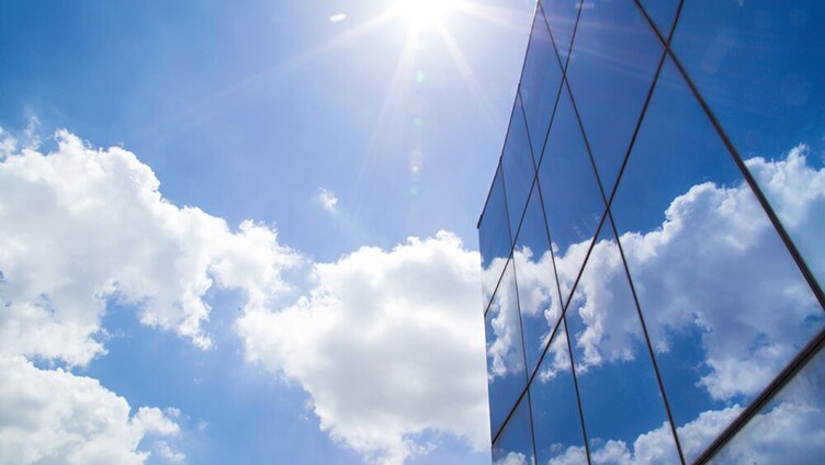 Glass building rising into the clouds
