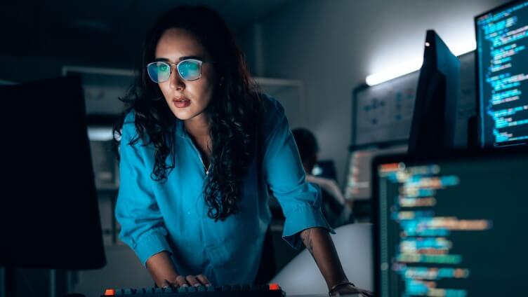 A Person looking into the monitor in dark