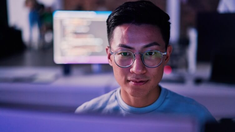 Closer view of a person Face who is looking into the monitor