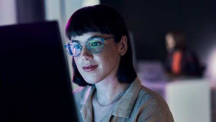 A Person sitting looking into the monitor