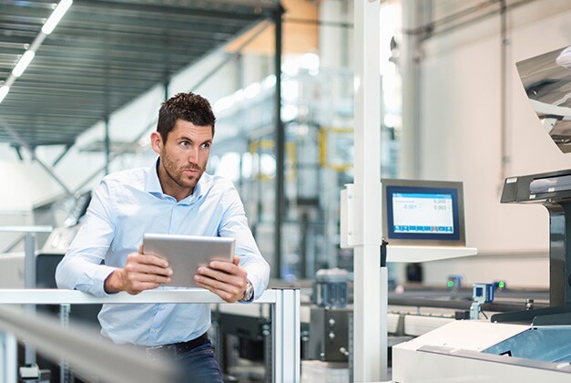 artificial intelligence professional looking at machinery