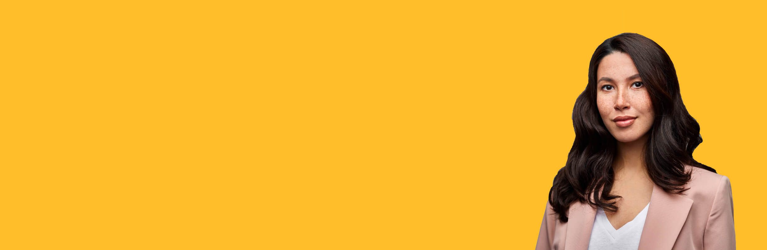 person in professional suit posing for the image with yellow background