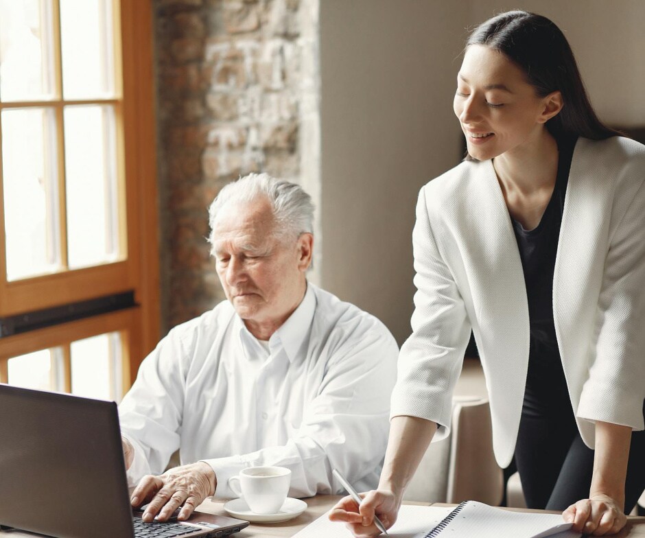 People discussing working on a laptop