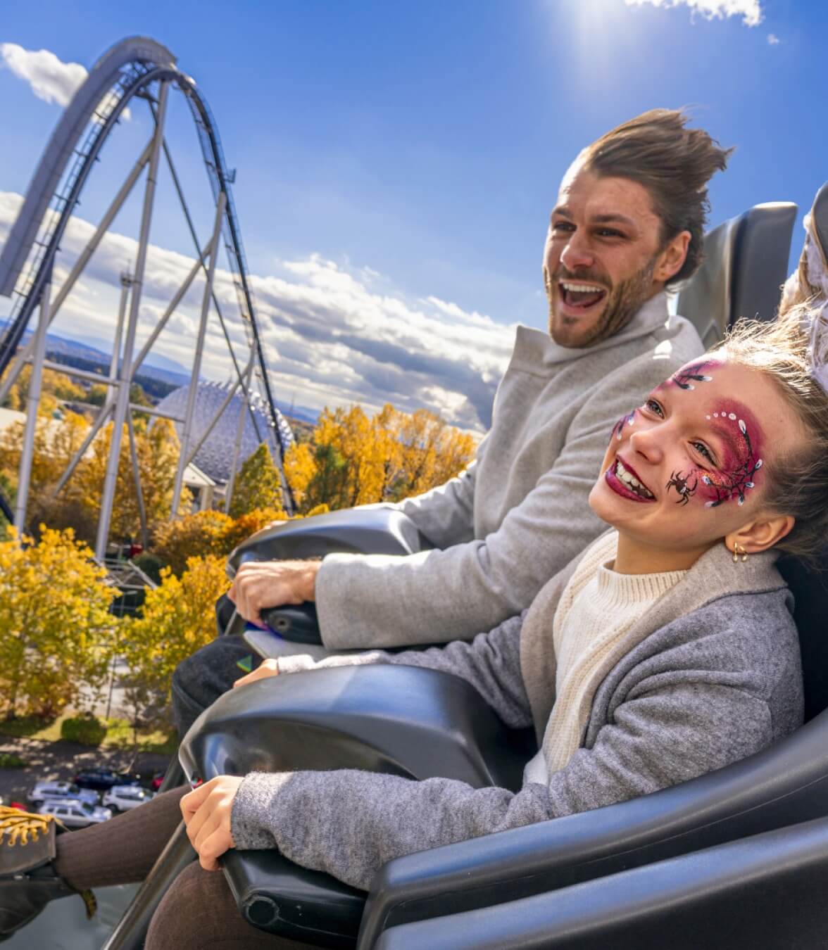 Visitors riding a high-speed Europa-Park roller coaster with scenic park views.
