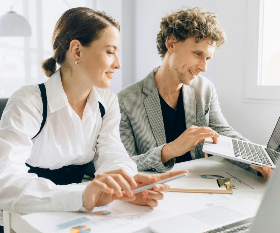 Business team reviewing analytics and technology plans together at a workspace.