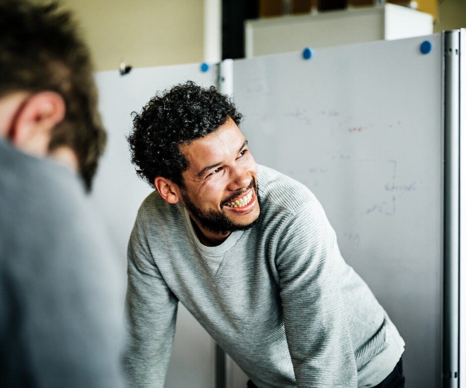 man smiling in management