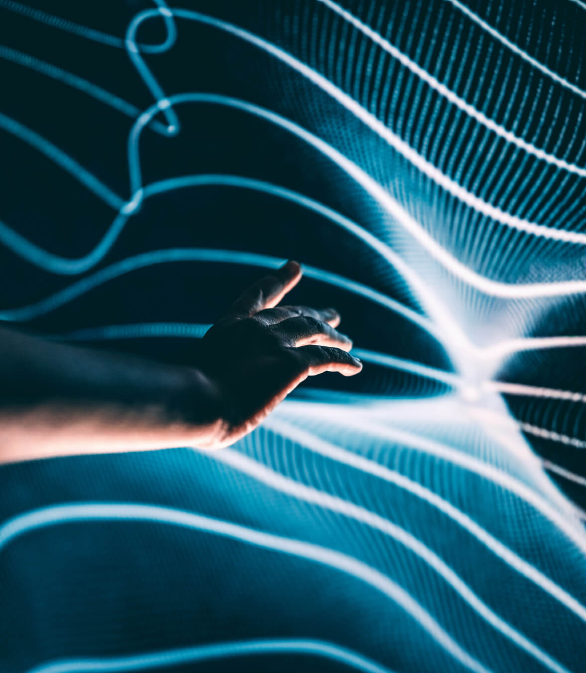 Hand interacting with abstract digital data streams representing modern cloud and database technology.