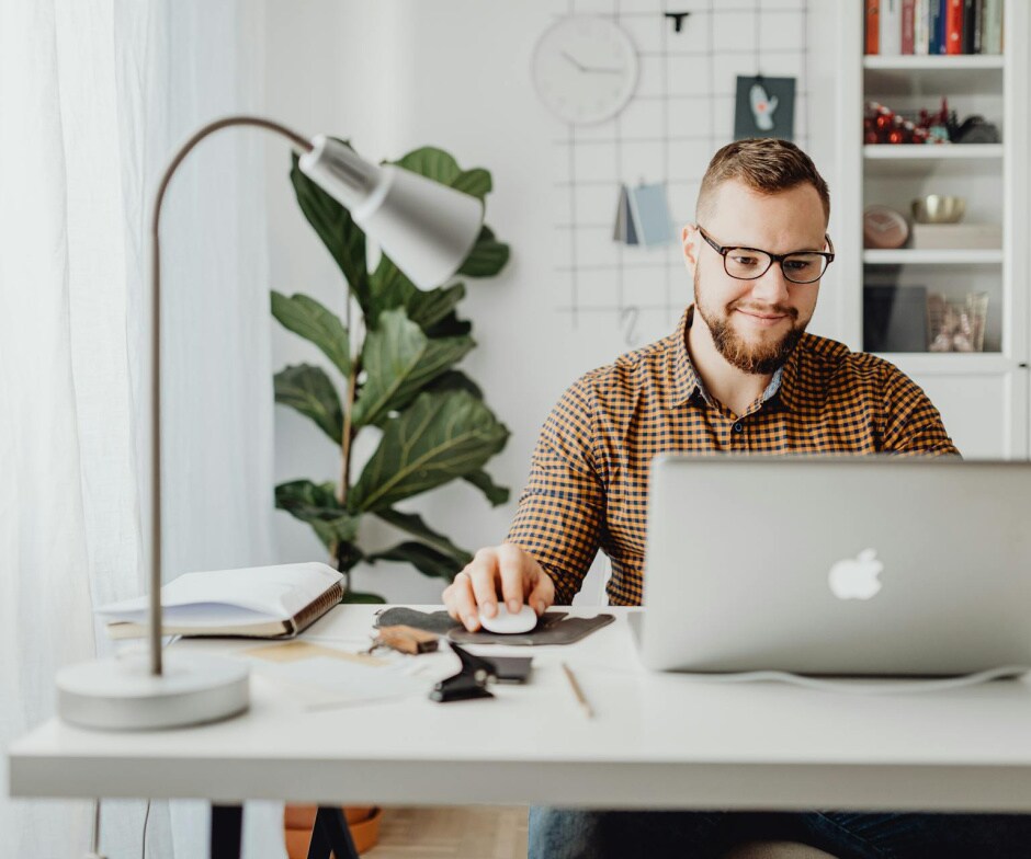 person sitting at desk on laptop