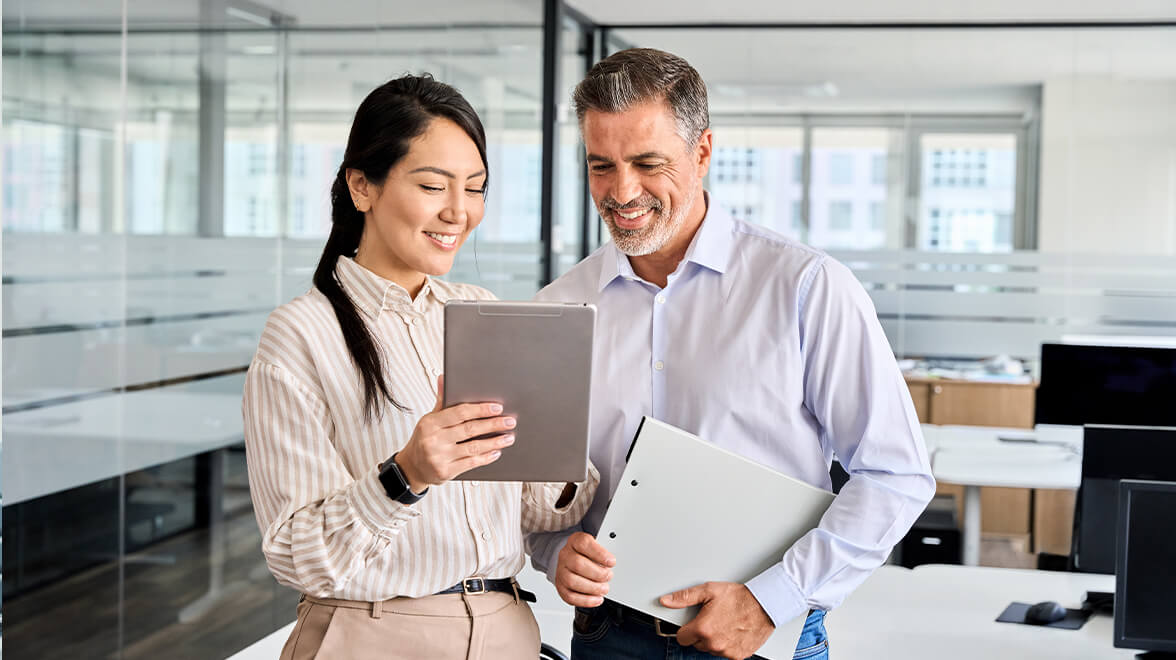 two people looking at the tablet inside the office