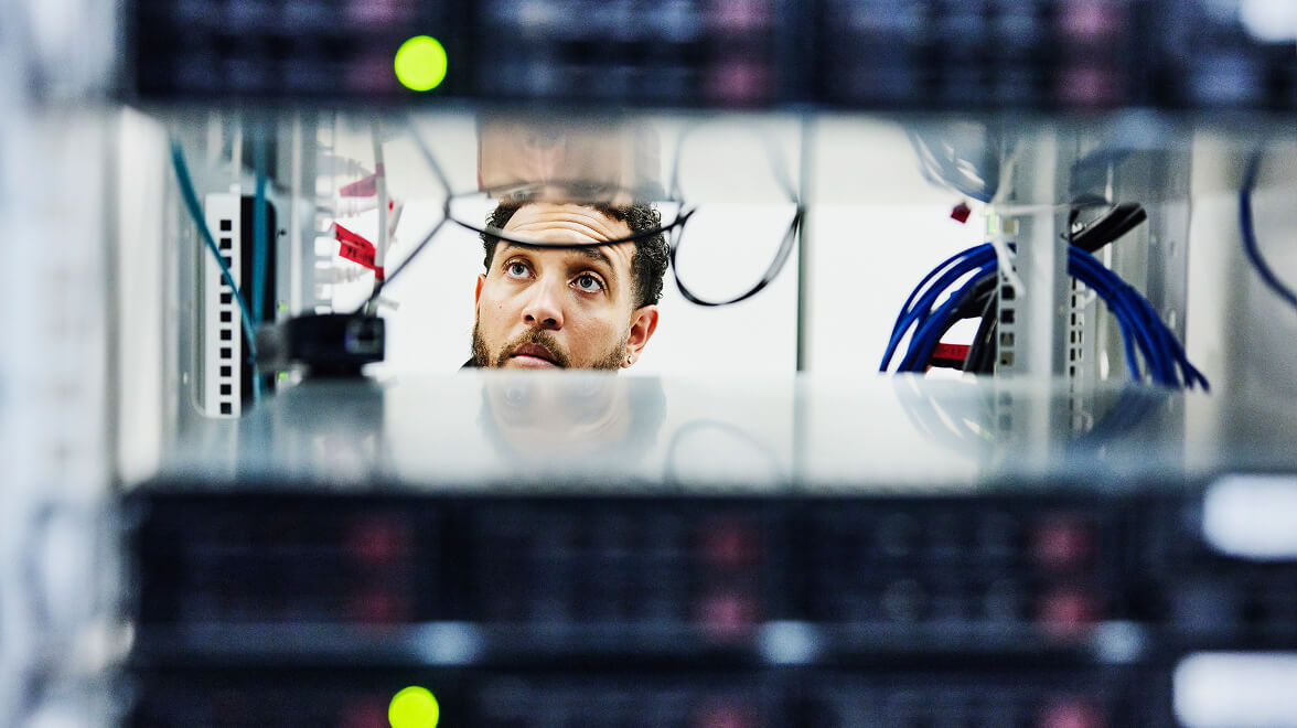 IT engineer managing servers and network infrastructure in a modern enterprise data center.