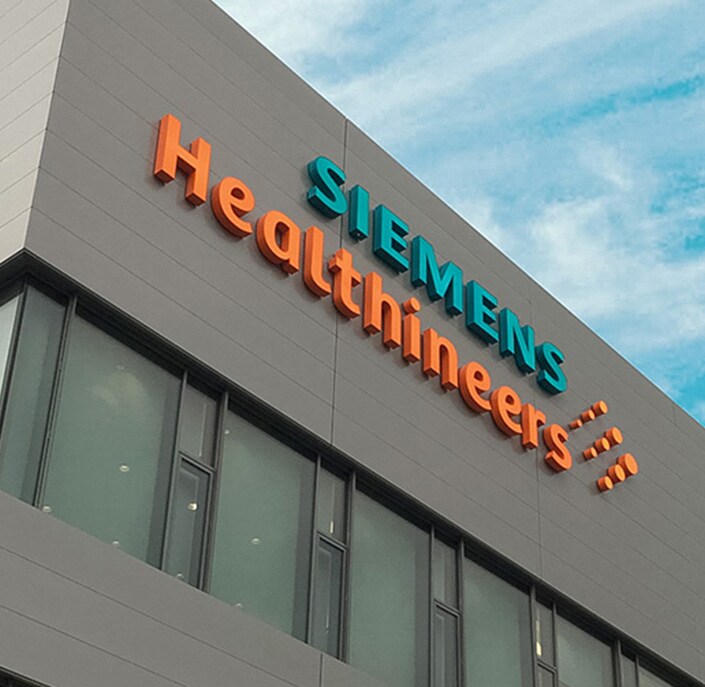 a large building with a sign that reads Siemens Healthineers