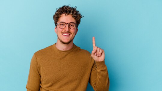 A person with a blue background posing to camera