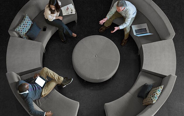 overhead view of people sitting on circular sectional with round centerpiece
