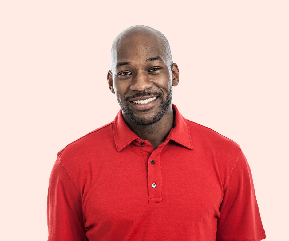 smiling guy in red shirt with peach background
