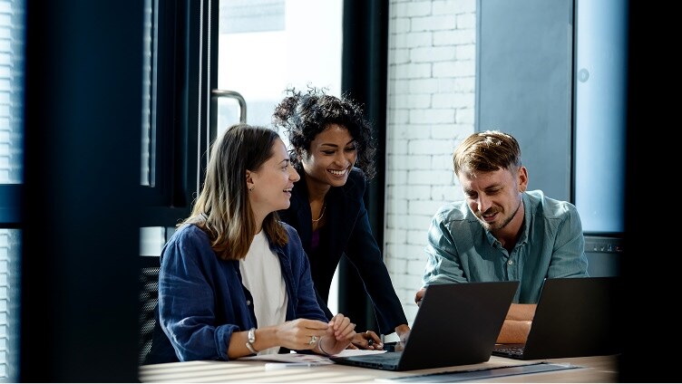 person sitting in front of monitors and analyzing